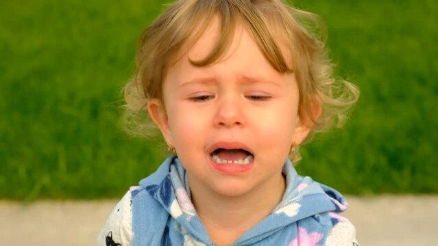child crying in the park. Selective focus.
