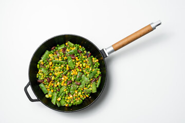 healthy vegetables, beans and corn in a frying pan isolated on a white background