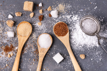 Various types of sugar in bamboo spoons, wholemeal, white and liquorice flavoured - 685824018