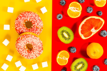 Healthy and unhealthy sugar, yellow, red background, juicy fruit next to sweet donut and processed...