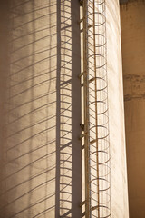Close-up of an access ladder in a cement plant's concrete storage tanks