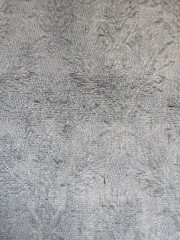 Primer plano de tejido, textura gris con ligeros brocados difuminados, con textura