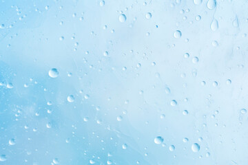 Pale blue background with small water drops, pastel colors, minimalist appearance. Full frame.