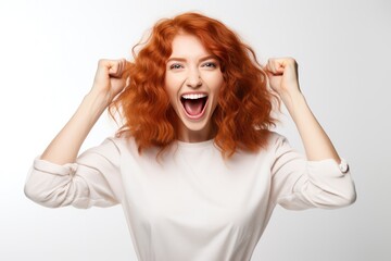 Energetic Redhead Spreading Joy And Positivity On The Background Of White Wall