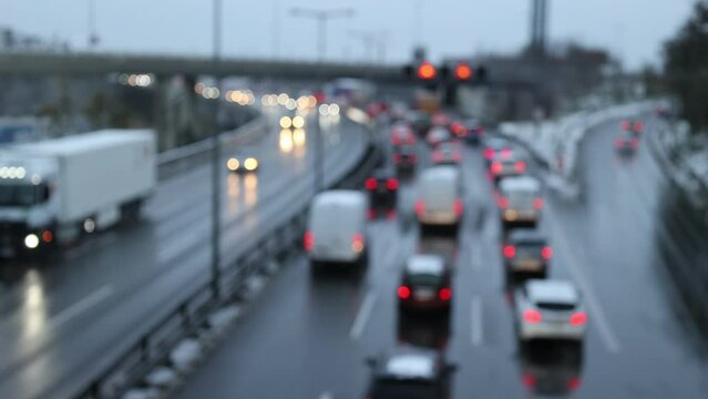 City highway in rush hour with traffic jams and moving traffic on a winter afternoon with blurred cars and lights (out of focus)
