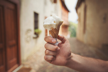 Artisanal Gelato Ice cream cone sweet dessert in Italian city. Close-up of Italian ice cream in a...