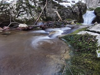Mountain stream in winter. Ice and snow on a beautiful mountain creek