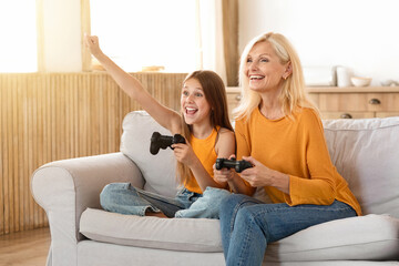 Happy grandmother and granddaughter have fun at home