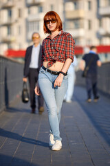 Stylish Redhead Woman in Urban Autumn Fashion. Smiling