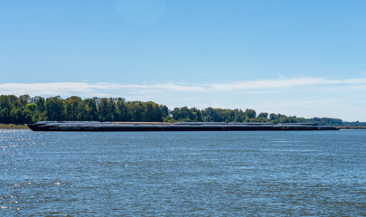 Large tug boat pushing rows of barges with grain products up the Mississippi river south of Cairo...