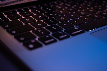 Laptop keyboard with backlight at the night office