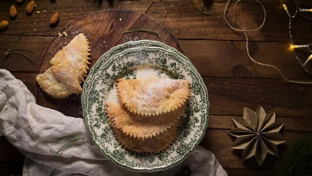A crescent-shaped pastry whose filling is made of eggs and almonds wrapped in crispy dough, cut in an artisanal way and sprinkled with sugar.