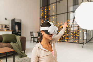 Utilizing a virtual reality headset, a fitness trainer leads online workout sessions at home during...