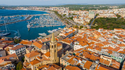 Aerial view of the old town of Alghero in Sardinia. Photo taken with a drone on a sunny day. Panoramic view of the old town and harbor of Alghero, Sardinia, Italy.
