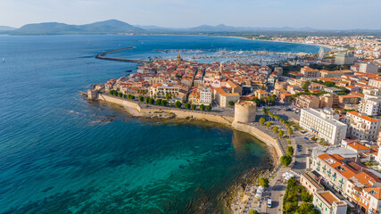 Aerial view of the old town of Alghero in Sardinia. Photo taken with a drone on a sunny day. Panoramic view of the old town and harbor of Alghero, Sardinia, Italy. - obrazy, fototapety, plakaty