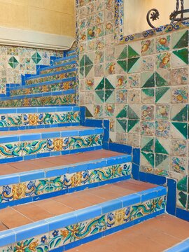 Stairs up decorated with colourful tiles in Spanish tradition in Spain. Vertical photo