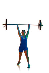 Fototapeta na wymiar Full-length of young girl in blue bodysuit training, lifting heavy barbell against white background in neon light. Concept of sport, strength, gym, healthy lifestyle, power, endurance, weightlifting.