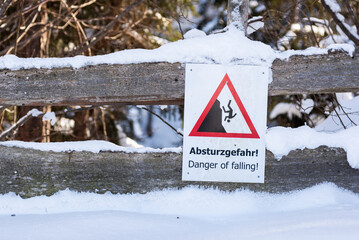 Danger of falling - warning sign, winter services. Schladming-Dachstein, Dachstein massif, Liezen District, Styria, Austria, Europe - 685879074