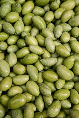 Top down view of freshly harvested, clean and ready to be used green olives, vertical