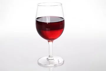 Fotobehang Red wine in a Glass isolated on white © paul