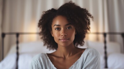 Indoor scene: Afro woman on a white bed.