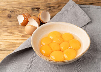 Egg Yolks in Bowl, Fresh Chicken Egg Yolk Separated from Whites for Cooking Recipe, Organic Yolks Top View