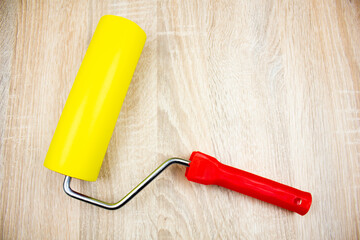 Roller on a wooden table. Roller for painting, renovation, repair.