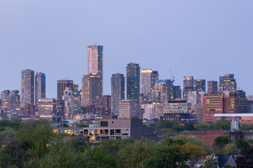 City skyline lights beginning to turn on at dusk during blue hour