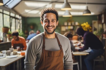 Portrait of a smiling young man working as a volunteer - obrazy, fototapety, plakaty