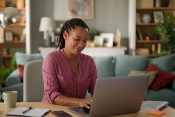 African American woman working on laptop at home office