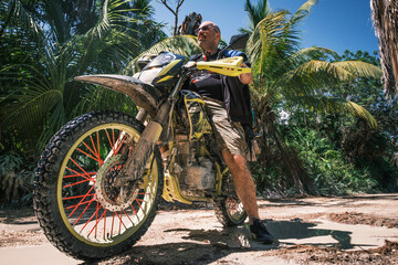 off road rider biker riding a motorcycle adventure in jungle 