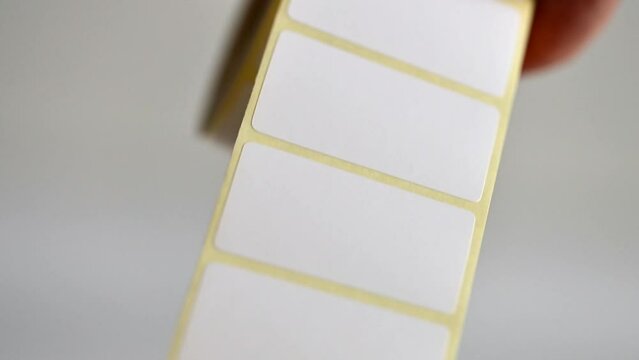 Opening barcode roll labels by hand. Opened thermal barcode roll.