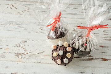 Chocolate bomb with cocoa powder and mini marshmallow to prepare a fragrant hot drink. Packed like a gift.