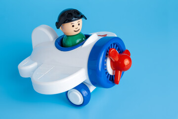 Toy children's plastic air plane with propeller isolated on blue background
