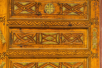 Wood carving with sacred geometric patterns. Manual labor of a woodworking master