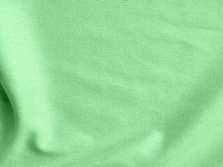 Factory textile fabric material surface green colored background with thread