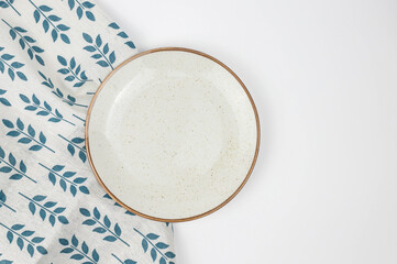 Empty white ceramic plate with napkin on white background, cooking, place for meal