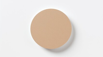 a round sticker mockup on a white surface, featuring a brown gift box in a modern minimalist style.