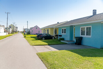colorful houses in north carolina near the atlantic ocean. Palm trees and blue sky.