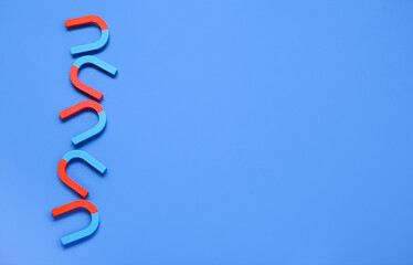 Horseshoe shaped magnets on blue background