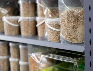 Closeup of packages with natural organic dry pelleted turtle food displayed in retail store..