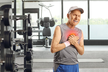 Elderly man in sportswear experiencing pain in the chest