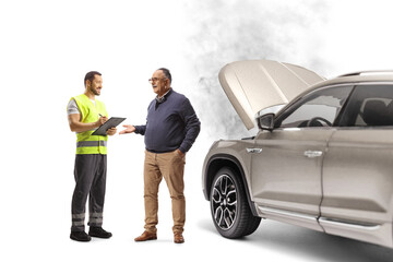 Full length shot of an mature man with a car problem talking to a road assistance worker