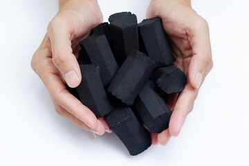 close up photo of cylindrical charcoal briquettes