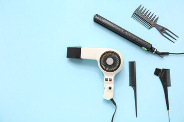 Different hairdressing tools on light blue background