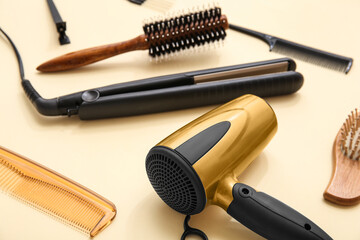 Different hairdressing tools on beige background