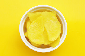 Sweet and tart slices of yellow pickled daikon, known as takuan in Japan and danmuji in Korea.