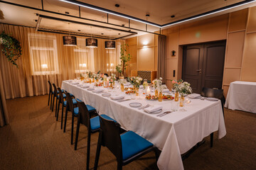 a long table served with dishes and flowers.