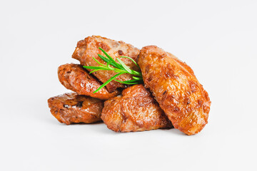 Chicken wings fried until half cooked, semi-finished product with fresh herbs on a white...