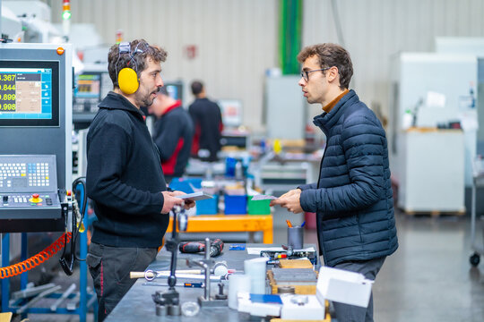 Engineers during a quality control in a cnc factory